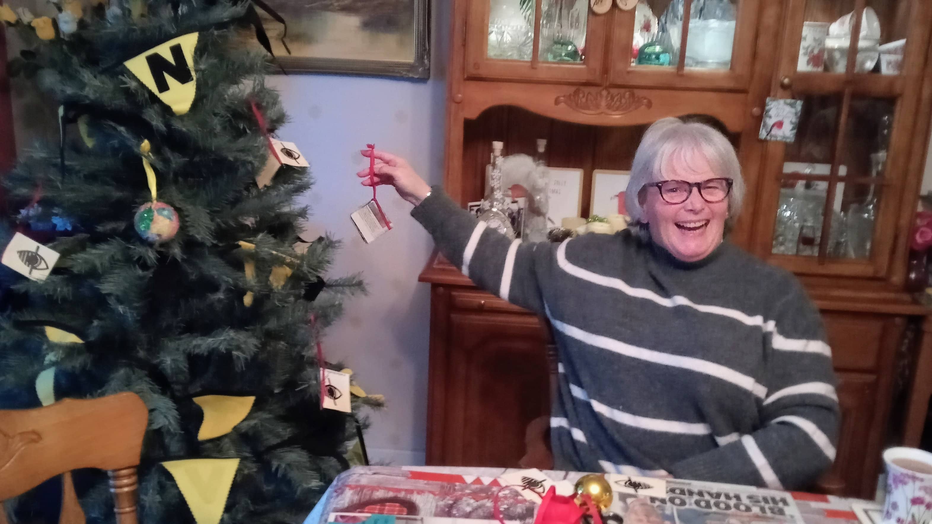 VTN Volunteer Lorraine Middleburgh putting a decoration on a Christmas tree